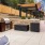 a patio with a grill and a table with chairs