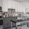 a kitchen with white cabinets and dark granite countertops