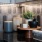 a kitchen counter with jars and plants on it