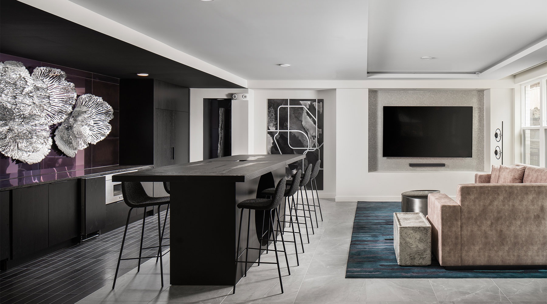 a lounge with a kitchen and a couch