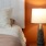 a lamp next to a bed